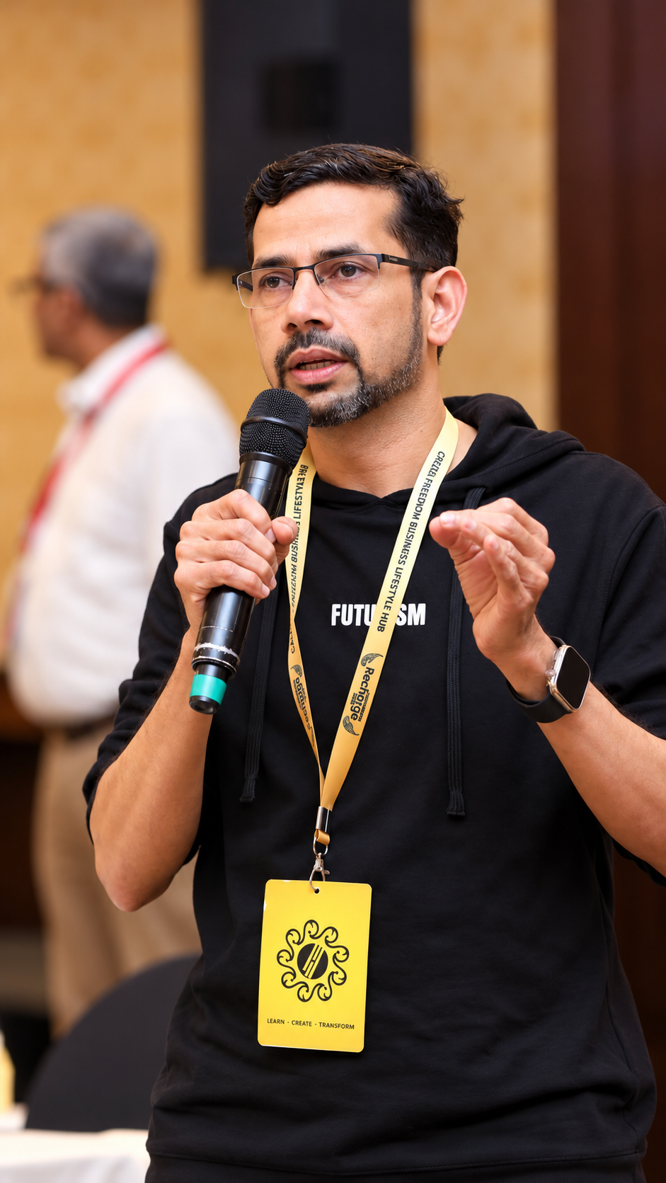 Ismayil TP, Floral Design Mentor, speaking on stage at a creative conference